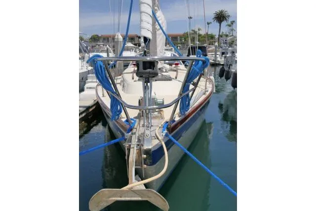 Slide: The Image of 1978 Tartan 37 sailboat docked in marina, featuring blue ropes and anchor. - 47