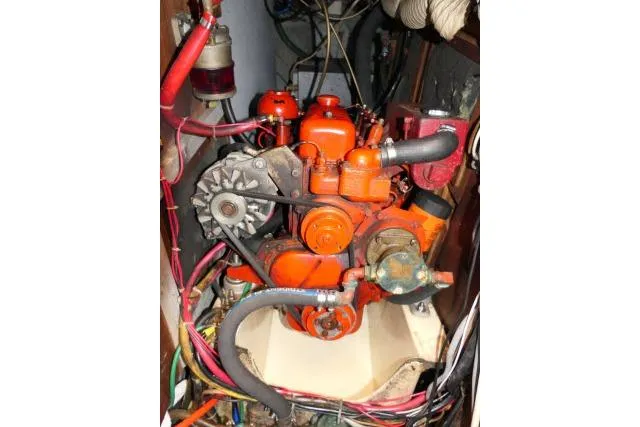 Slide: The Image of Engine of a 1978 Tartan 37 sailboat, featuring orange components and visible wiring. - 50