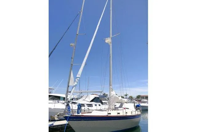 Slide: The Image of 1978 Tartan 37 sailboat docked in marina under clear blue sky. - 53