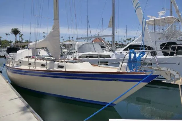 Slide: The Image of 1978 Tartan 37 sailboat docked in a marina under clear skies. - 55
