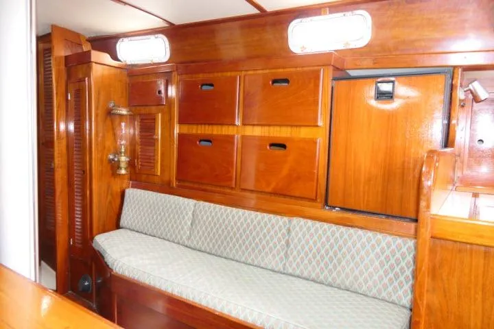 Slide: The Image of 1978 Tartan 37 interior with wooden cabinetry and cushioned seating. - 6