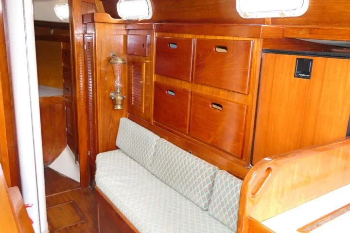 Slide: The Image of Interior of a 1978 Tartan 37 sailboat with wooden cabinetry and cushioned seating. - 7