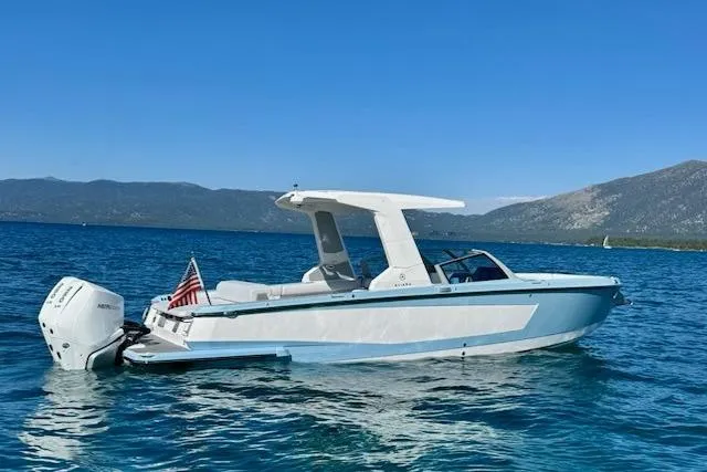 The Image of 2024 Aviara AV28 OB boat on clear blue water with scenic mountain backdrop. - 0