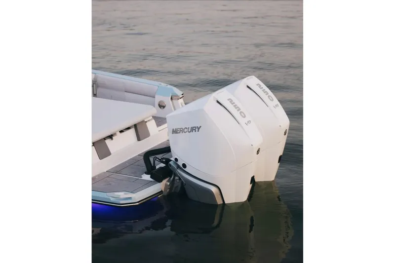 Slide: The Image of 2024 Aviara AV28 OB boat with dual Mercury outboard engines on calm water. - 4