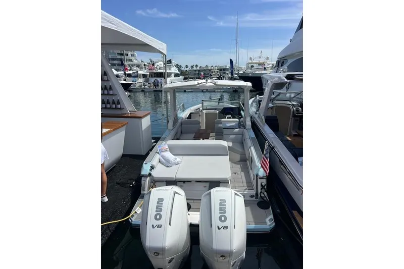 Slide: The Image of 2024 Aviara AV28 OB boat docked with twin outboard engines, marina view. - 7