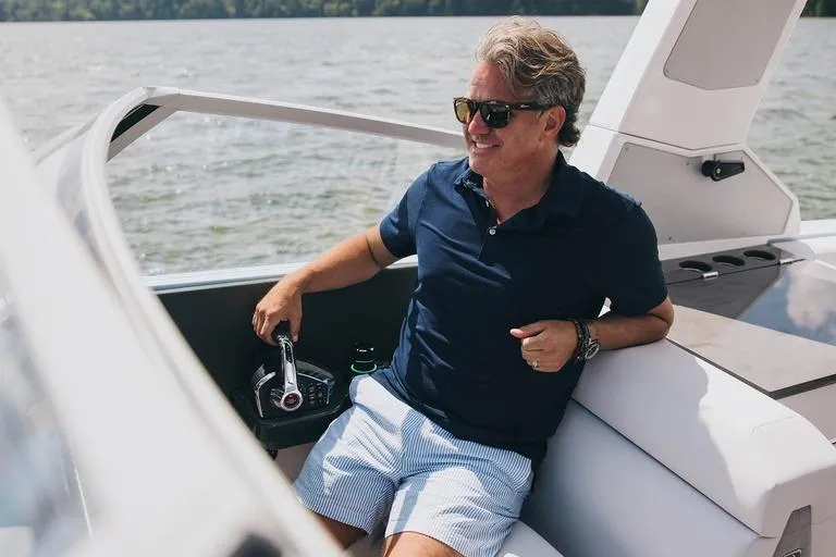 Slide: The Image of Man relaxing on a 2024 Aviara AV28 OB boat, enjoying a sunny day. - 8