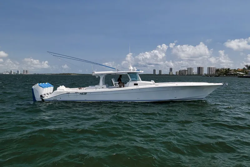 Slide: The Image of 2023 HCB 53 Suenos boat on open water under clear skies. - 5