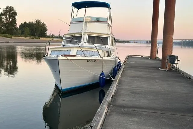 Slide: The Image of 1964 Pacemaker Flybridge cruise boat docked at serene riverside during sunset. - 1