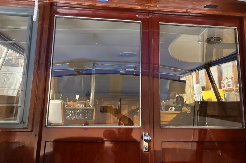 Slide: The Image of 1964 Pacemaker Flybridge Cruise interior with polished wood and nautical controls. - 11