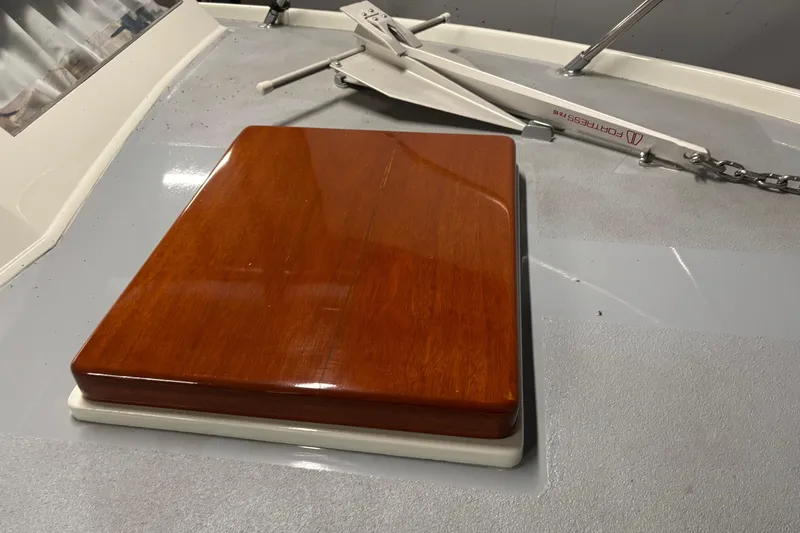 Slide: The Image of 1964 Pacemaker Flybridge Cruise boat deck with polished wood panel and anchor. - 12