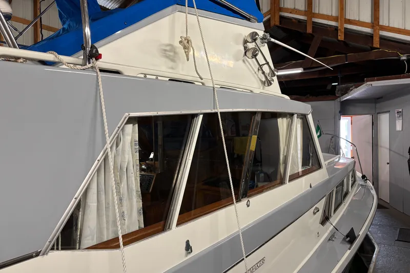 Slide: The Image of 1964 Pacemaker Flybridge Cruise boat in a storage facility, showcasing classic design and structure. - 5