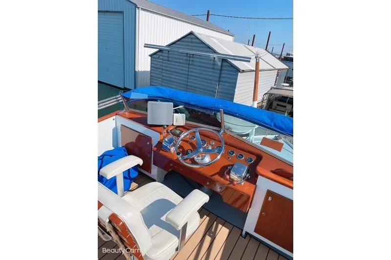 Slide: The Image of 1964 Pacemaker Flybridge Cruise boat cockpit with wooden dashboard and steering wheel. - 7