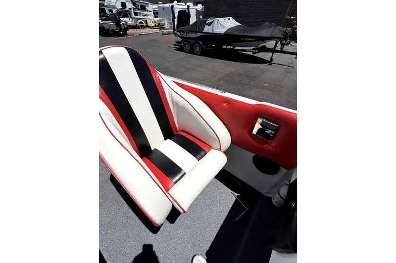 Slide: The Image of 1979 Charger 30 Cuddy boat interior with red, black, and white seating. - 11