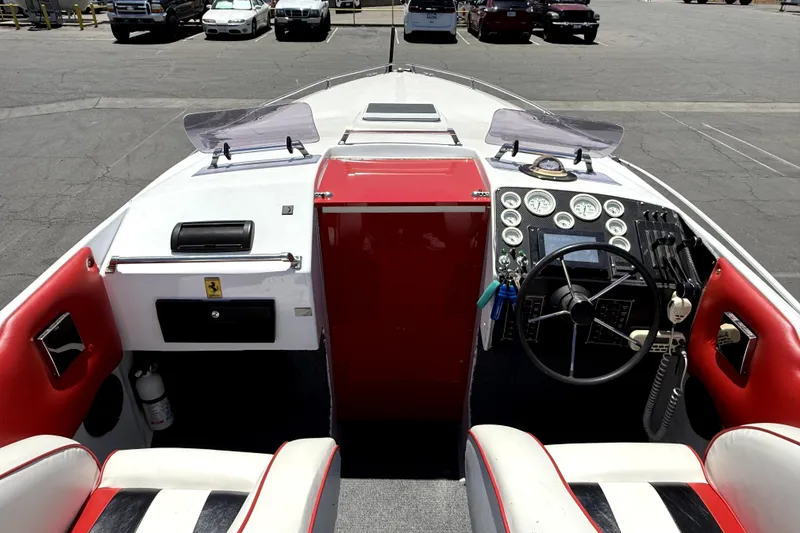Slide: The Image of 1979 Charger 30 Cuddy boat interior with red and white seating, dashboard, and steering wheel. - 12