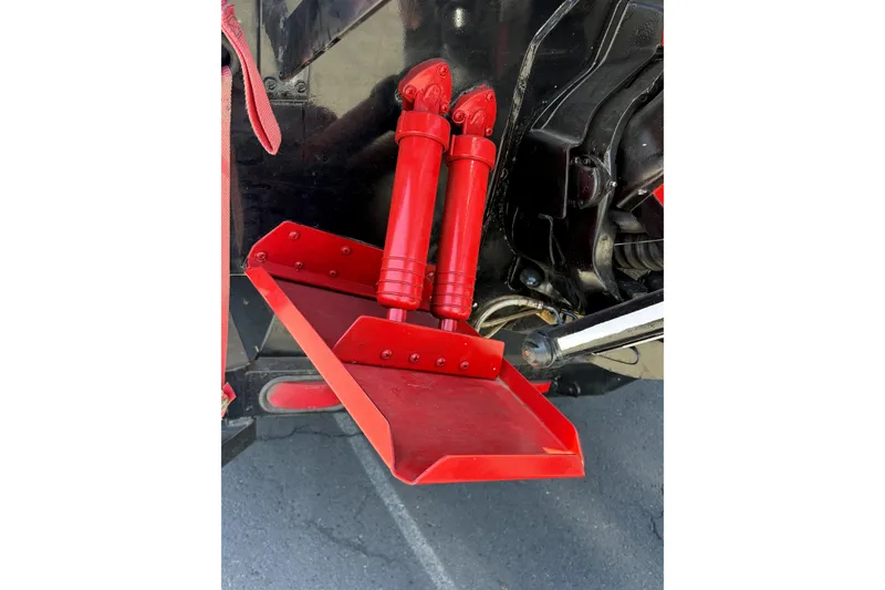 Slide: The Image of Red hydraulic trim tabs on a 1979 Charger 30 Cuddy boat. - 13