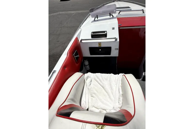 Slide: The Image of 1979 Charger 30 Cuddy boat interior with red and white seating and dashboard. - 14