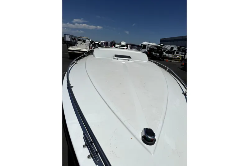 Slide: The Image of 1979 Charger 30 Cuddy boat, white deck, parked outdoors under clear sky. - 15