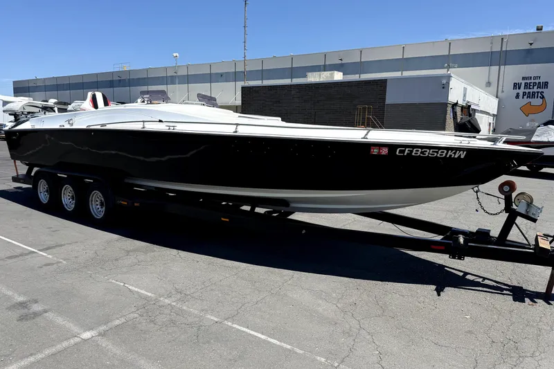 The Image of 1979 Charger 30 Cuddy boat on trailer, parked near RV repair shop. - 2