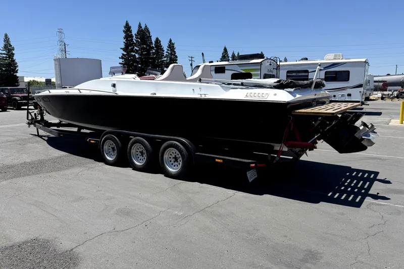 Slide: The Image of 1979 Charger 30 Cuddy boat on trailer in parking lot, sunny day. - 3