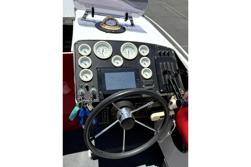 Slide: The Image of 1979 Charger 30 Cuddy boat dashboard with gauges, steering wheel, and controls. - 6