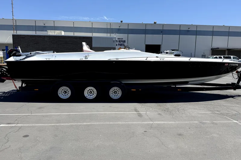 Slide: The Image of 1979 Charger 30 Cuddy boat on trailer, parked in industrial area. - 7