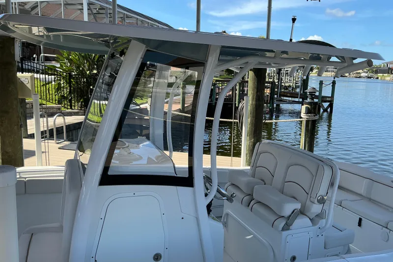 Slide: The Image of 2019 Sea Hunt Ultra 255 SE boat docked, featuring sleek seating and modern design. - 12