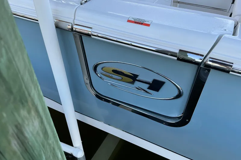 Slide: The Image of 2019 Sea Hunt Ultra 255 SE boat with SH logo and sleek design. - 13