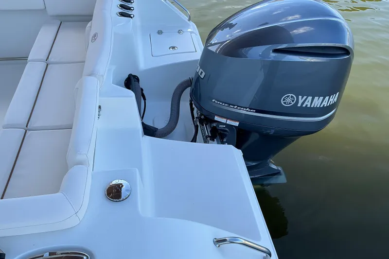Slide: The Image of 2019 Sea Hunt Ultra 255 SE boat with Yamaha outboard motor on calm water. - 15