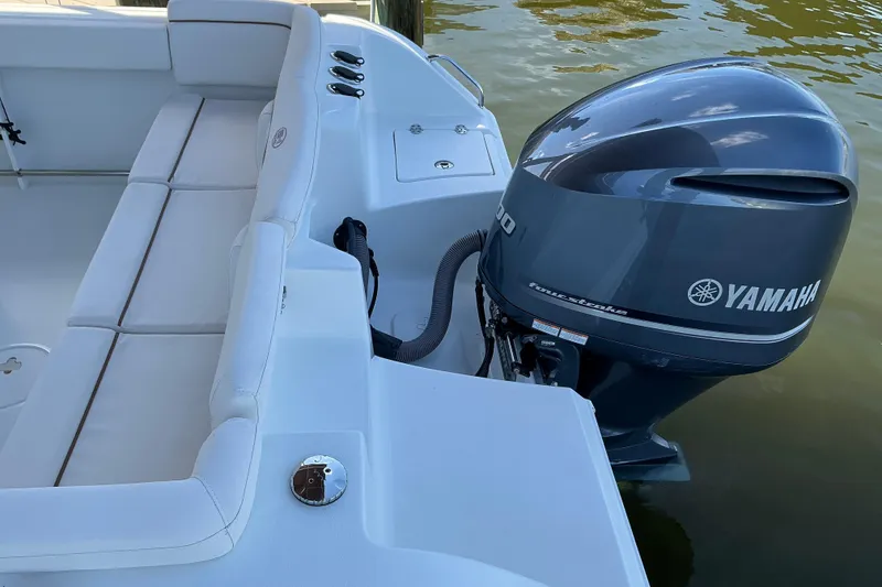 Slide: The Image of 2019 Sea Hunt Ultra 255 SE boat with Yamaha outboard motor on calm water. - 16