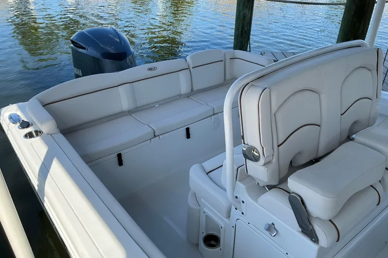 Slide: The Image of 2019 Sea Hunt Ultra 255 SE boat interior with white seating and Yamaha outboard motor. - 19