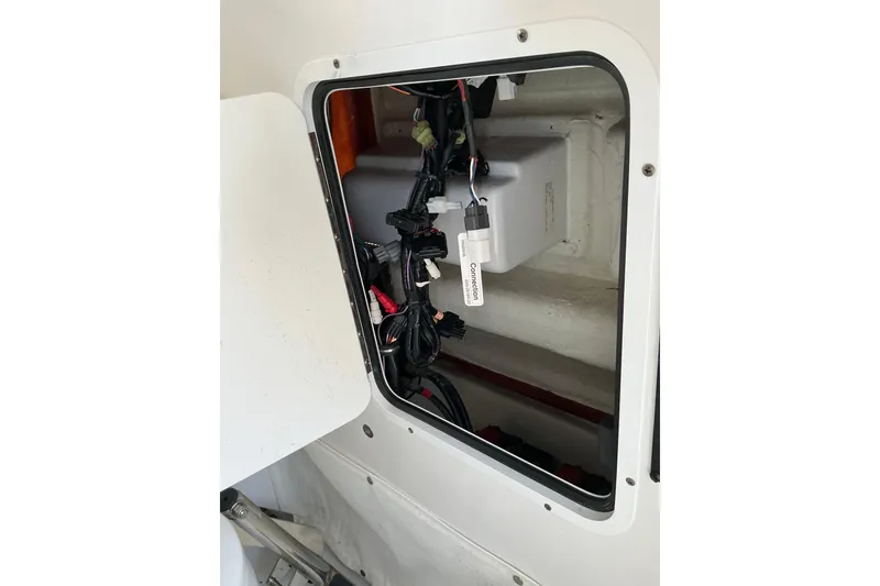 Slide: The Image of Access panel of a 2019 Sea Hunt Ultra 255 SE boat, showing internal wiring. - 23