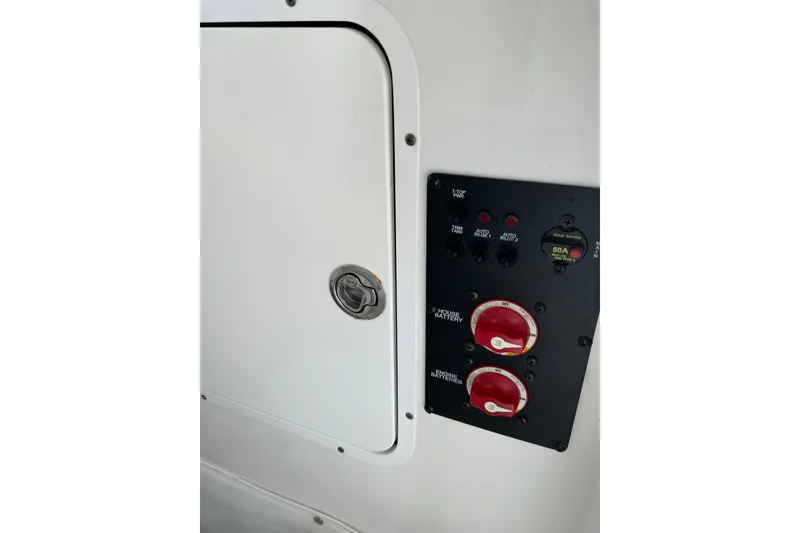 Slide: The Image of Control panel of a 2019 Sea Hunt Ultra 255 SE boat, featuring battery switches. - 24