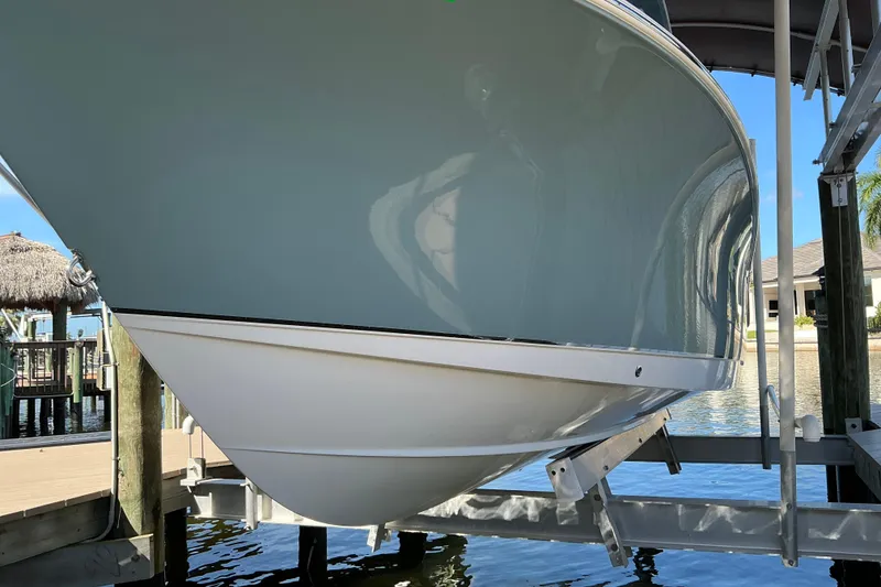 Slide: The Image of 2019 Sea Hunt Ultra 255 SE boat on lift, dockside view. - 3