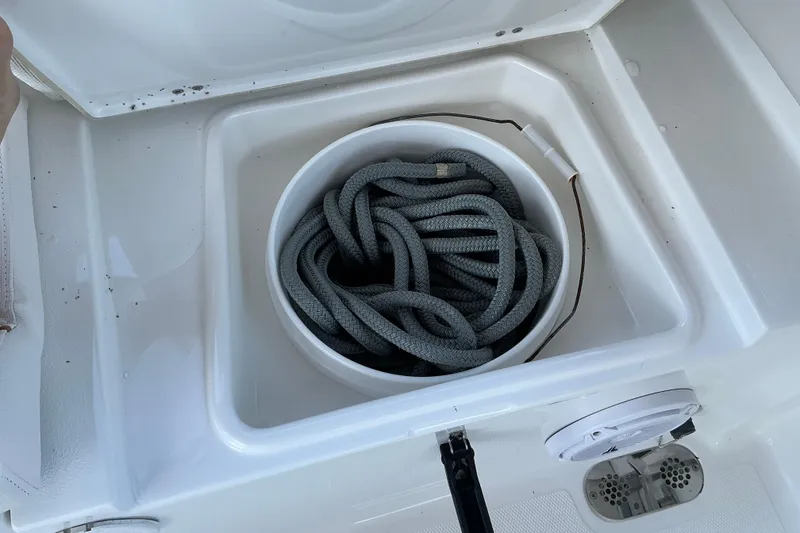 Slide: The Image of Coiled rope in storage compartment of 2019 Sea Hunt Ultra 255 SE boat. - 35