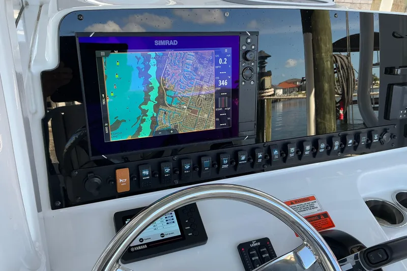 Slide: The Image of Dashboard of 2019 Sea Hunt Ultra 255 SE with navigation display and controls. - 37