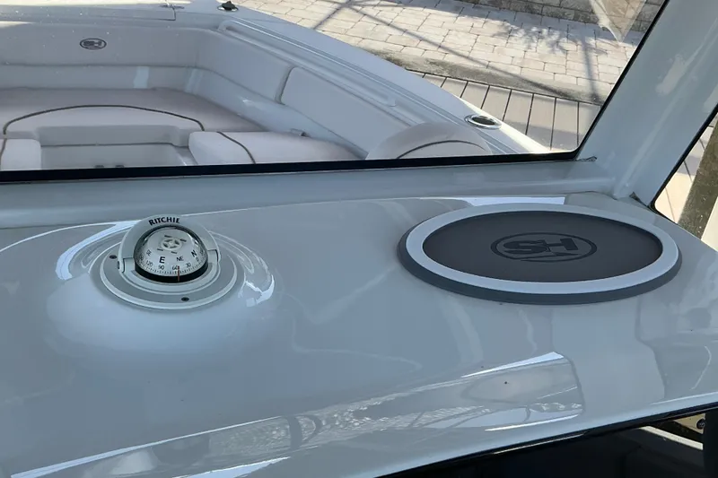 Slide: The Image of 2019 Sea Hunt Ultra 255 SE dashboard with compass and logo mat. - 46