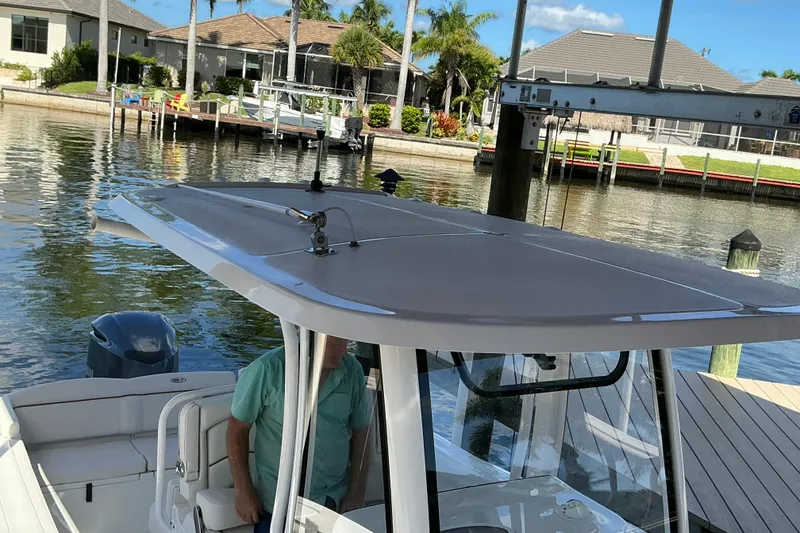 Slide: The Image of 2019 Sea Hunt Ultra 255 SE boat docked in a scenic waterfront setting. - 48