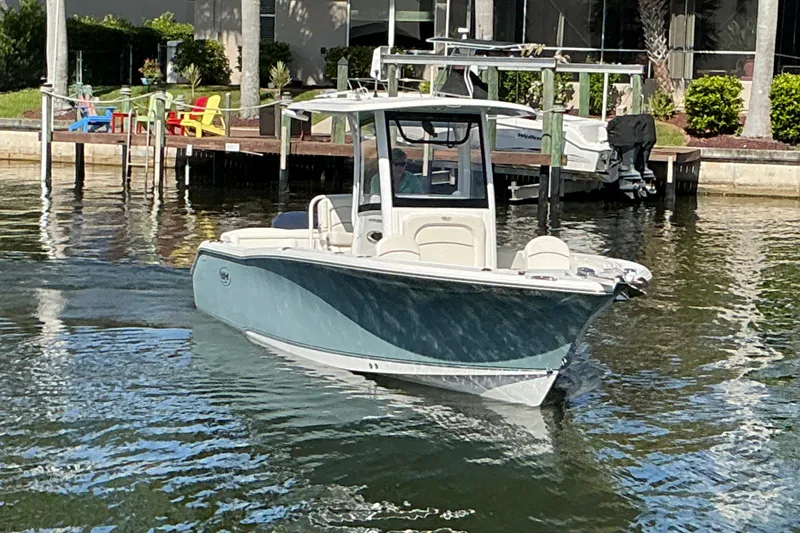 Slide: The Image of 2019 Sea Hunt Ultra 255 SE boat cruising in a sunny waterfront setting. - 54