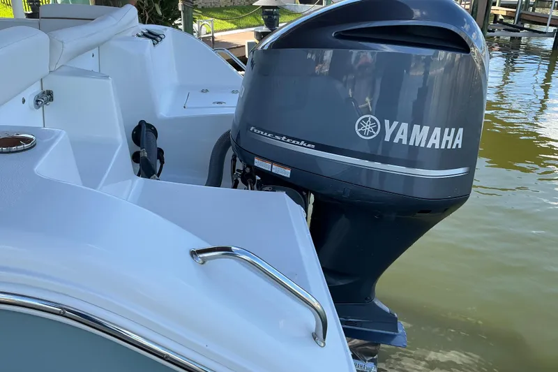 Slide: The Image of 2019 Sea Hunt Ultra 255 SE with Yamaha outboard motor on calm water. - 56