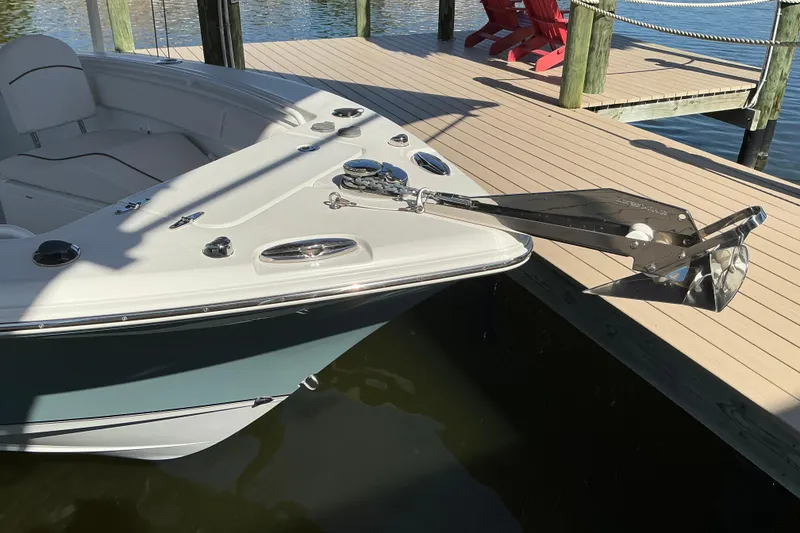 Slide: The Image of 2019 Sea Hunt Ultra 255 SE boat docked, featuring a sleek anchor and spacious seating. - 9