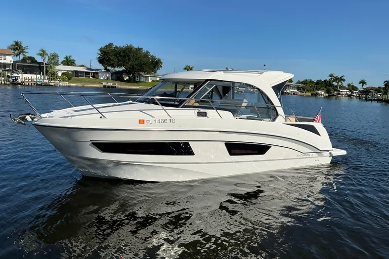 Slide: The Image of 2022 Beneteau Antares 9 boat cruising on a sunny day in a scenic waterway. - 1