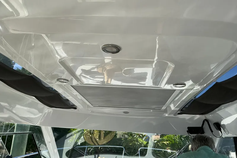 Slide: The Image of Interior view of 2022 Beneteau Antares 9 boat ceiling with sleek design and lighting. - 14