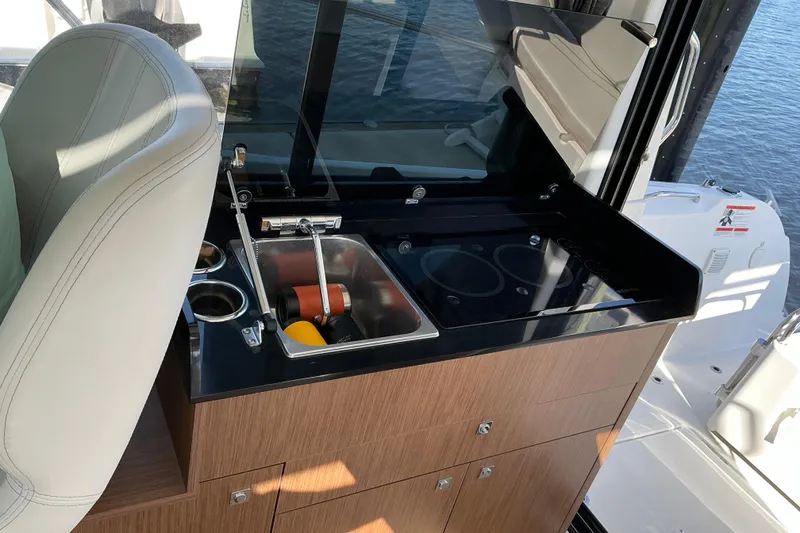 Slide: The Image of 2022 Beneteau Antares 9 interior with compact kitchen sink and countertop. - 15