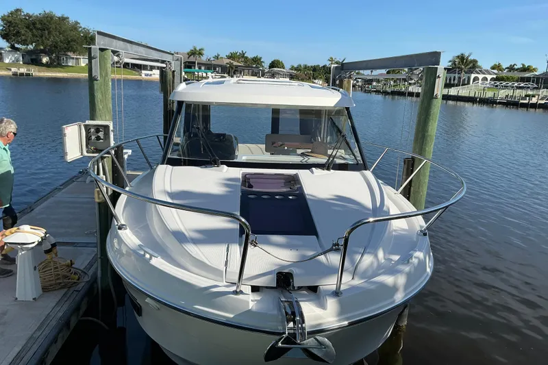 Slide: The Image of 2022 Beneteau Antares 9 docked at a marina, showcasing sleek design and modern features. - 2
