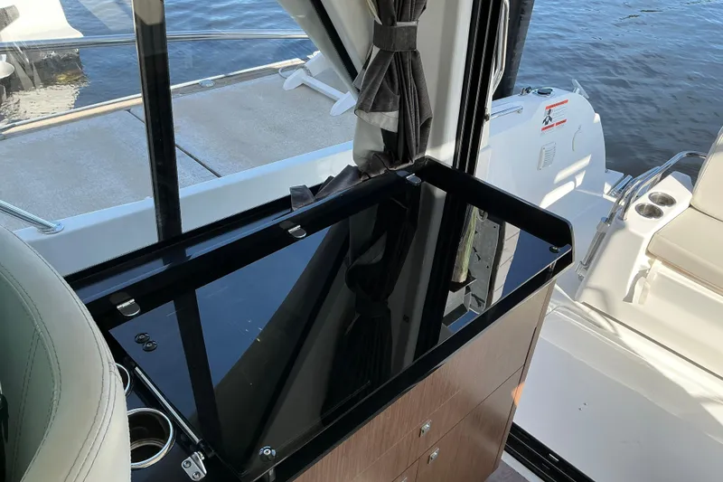 Slide: The Image of Interior view of 2022 Beneteau Antares 9, featuring sleek cabinetry and water views. - 25