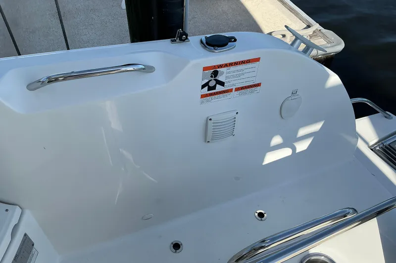Slide: The Image of Beneteau Antares 9 boat deck, 2022 model, featuring safety warning labels and stainless steel railings. - 26