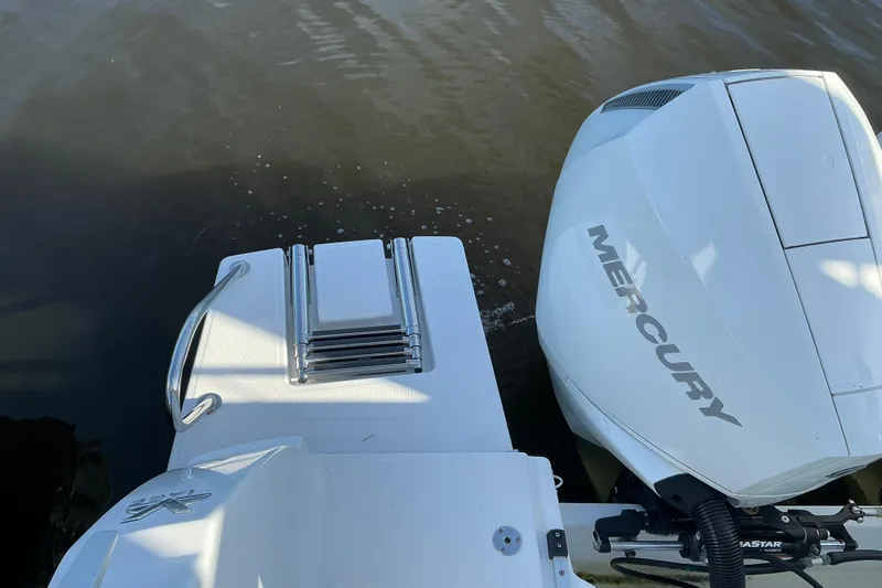 Slide: The Image of 2022 Beneteau Antares 9 with Mercury outboard engine and swim platform ladder. - 27
