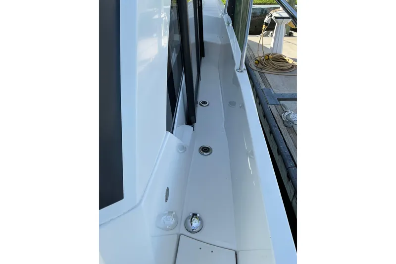 Slide: The Image of 2022 Beneteau Antares 9 boat deck with sleek design and dockside view. - 29
