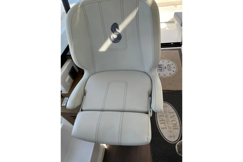 Slide: The Image of Luxury seating on 2022 Beneteau Antares 9 boat, featuring elegant white upholstery. - 34