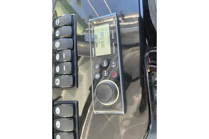 Slide: The Image of Control panel of a 2022 Beneteau Antares 9 boat with radio and buttons. - 35